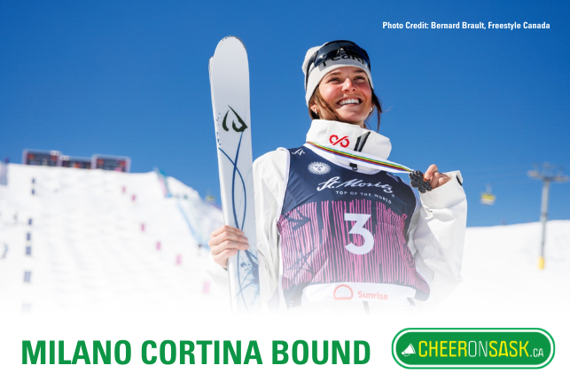 Maia Schwinghammer poses holding up medal in front of ski hill.